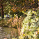 Two people walk down the trail at Lake Artemesia in College Park on Oct. 17, 2023. (Neelay Sachdeva/The Diamondback)