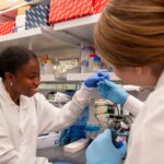 Ademide Adeyemo and Caroline Hobson collaborate at the lab bench